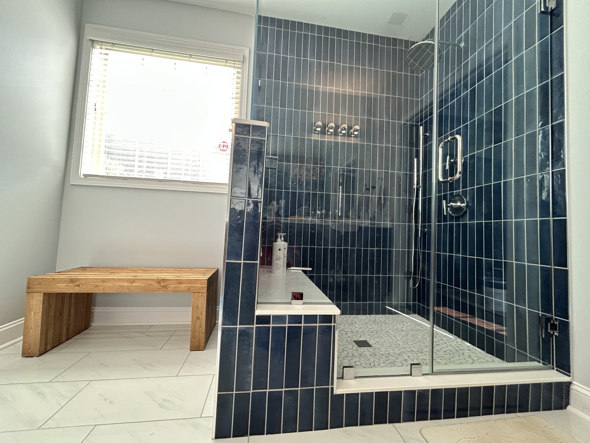 Custom navy tile shower with glass enclosure by Tile Yoda near Greenville, SC