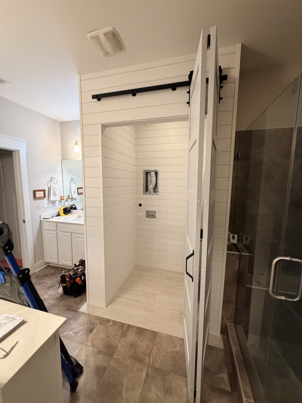 Finished, with the hookups and dryer vent set into the wall by Tile Yoda