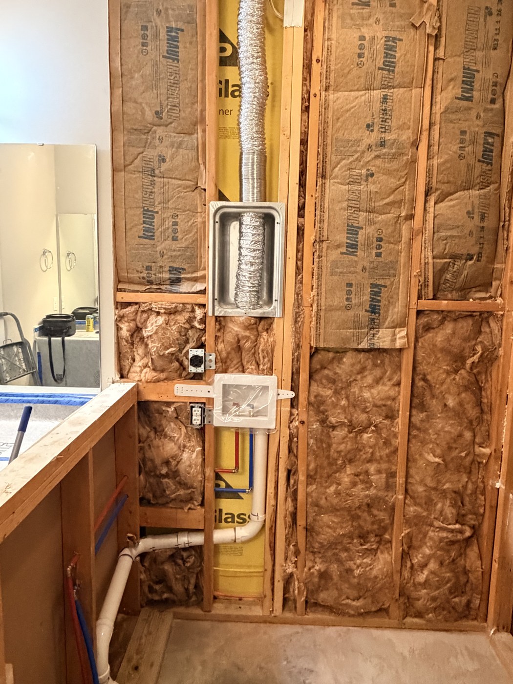 New wall framed with the two inch drain, supply lines and dryer duct run inside it, by Tile Yoda in Taylors, SC